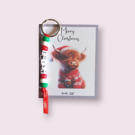 Personalised beaded Christmas keyring with a Highland cow backing card.